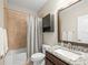 Neutral bathroom featuring granite countertop, tile surround, and dark wood vanity at 14209 Quintessa Ln, Lithia, FL 33547