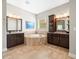 Luxurious bathroom featuring dual vanities and a soaking tub for relaxation at 14209 Quintessa Ln, Lithia, FL 33547