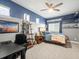 Inviting bedroom featuring two-tone walls, a bed, a desk, and a ceiling fan at 14209 Quintessa Ln, Lithia, FL 33547