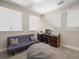 Well-lit bedroom featuring a cozy futon, workspace, and plush grey carpet at 14209 Quintessa Ln, Lithia, FL 33547