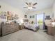 Bright bedroom with a cozy bed, dresser, desk, and ceiling fan at 14209 Quintessa Ln, Lithia, FL 33547
