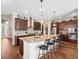 Bright kitchen with granite countertops, stainless steel appliances, and a center island with bar stool seating at 14209 Quintessa Ln, Lithia, FL 33547