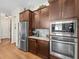 Spacious kitchen featuring built-in appliances, granite countertops, and mosaic tile backsplash at 14209 Quintessa Ln, Lithia, FL 33547