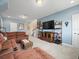 Living room featuring a large sectional couch, carpeted floors, and natural light at 14209 Quintessa Ln, Lithia, FL 33547