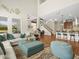 Open-concept living area with hardwood floors, large windows, and comfortable seating arrangement at 14209 Quintessa Ln, Lithia, FL 33547