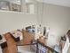 Bright living room with hardwood floors, a modern kitchen, and a grand staircase leading to upper floors at 14209 Quintessa Ln, Lithia, FL 33547