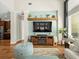 Open concept living area with hardwood floors, custom built-ins, and lots of light at 14209 Quintessa Ln, Lithia, FL 33547
