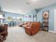 Spacious living room features a plush sectional couch, large windows, and plenty of room for relaxing at 14209 Quintessa Ln, Lithia, FL 33547