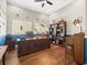 Home office featuring wood floors, a large desk, built-in shelves, and lots of sunlight at 14209 Quintessa Ln, Lithia, FL 33547