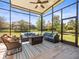 Inviting screened-in patio with a stylish outdoor seating area and a cozy fire pit at 14209 Quintessa Ln, Lithia, FL 33547