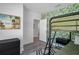 Bedroom featuring vibrant leaf-patterned wallpaper, bunk beds, and modern black furniture at 1432 19Th S St, St Petersburg, FL 33712