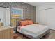 Cozy bedroom showcasing stylish wallpaper, natural light from a window, and modern wood flooring at 1432 19Th S St, St Petersburg, FL 33712