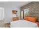 Bedroom featuring stylish wallpaper, natural light from a window, modern wood flooring and dresser at 1432 19Th S St, St Petersburg, FL 33712