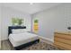 Bedroom featuring natural light, stylish geometric wallpaper, comfortable bed, and modern dresser at 1432 19Th S St, St Petersburg, FL 33712