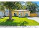 Charming yellow home with a well-maintained lawn, mature tree, and a new concrete driveway at 1432 19Th S St, St Petersburg, FL 33712