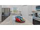 Bright kitchen boasts stainless appliances, granite counters, gray floors, and a functional center island at 1432 19Th S St, St Petersburg, FL 33712