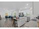 Open-concept kitchen, dining, and living area featuring modern appliances, and bar seating at 1432 19Th S St, St Petersburg, FL 33712