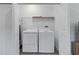 Bright laundry room features modern washer and dryer, plus convenient overhead shelving at 1432 19Th S St, St Petersburg, FL 33712