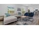 Open-concept living room flowing into the kitchen with modern seating and a stylish rug at 1432 19Th S St, St Petersburg, FL 33712