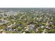 Expansive aerial view of a residential neighborhood with mature trees and well-maintained homes and multiple swimming pools at 14344 83Rd Pl, Seminole, FL 33776