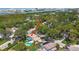 Expansive aerial view of a home with a pool, surrounded by lush greenery and waterways at 14344 83Rd Pl, Seminole, FL 33776