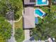 Beautiful aerial view of home with lush green trees, lawn, driveway, and sparkling swimming pools at 14344 83Rd Pl, Seminole, FL 33776