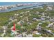 Aerial shot of a neighborhood with mature trees, showcasing a home with a private backyard pool at 14344 83Rd Pl, Seminole, FL 33776