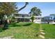 Lush backyard with a swimming pool, patio, and well-maintained lawn, perfect for outdoor entertaining at 14344 83Rd Pl, Seminole, FL 33776