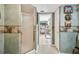 Artsy bathroom featuring a shower, and mosaic tiled walls that continue into a bright living space at 14344 83Rd Pl, Seminole, FL 33776