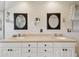Bathroom featuring double sinks, vanity with storage, and dual mirrors in a neutral color palette at 14344 83Rd Pl, Seminole, FL 33776