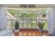 Bright bay window with white shutters, hardwood floor, and decor features at 14344 83Rd Pl, Seminole, FL 33776