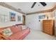 A cozy bedroom shows a decorative trim, a daybed and a ceiling fan at 14344 83Rd Pl, Seminole, FL 33776
