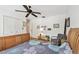 Inviting bedroom featuring a ceiling fan, closet, wood floors, and a comfortable seating area at 14344 83Rd Pl, Seminole, FL 33776