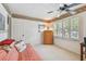 Cozy bedroom with a large window, louvred blinds, closet, and futon at 14344 83Rd Pl, Seminole, FL 33776