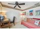 A quaint bedroom featuring a single bed, desk, and ample natural light at 14344 83Rd Pl, Seminole, FL 33776