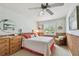 Comfortable bedroom with ceiling fan, classic furniture and outdoor views at 14344 83Rd Pl, Seminole, FL 33776