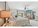 Bedroom with backyard access through French doors, with neutral tones and a ceiling fan at 14344 83Rd Pl, Seminole, FL 33776