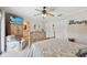 Bedroom featuring a TV, ceiling fan, backyard access, and an ensuite bathroom at 14344 83Rd Pl, Seminole, FL 33776