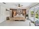 Bright bedroom featuring a ceiling fan, backyard access, and a neutral color palette at 14344 83Rd Pl, Seminole, FL 33776