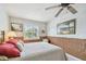 Cozy bedroom featuring light blue walls, a ceiling fan, and bamboo style lower walls at 14344 83Rd Pl, Seminole, FL 33776