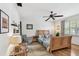 Charming bedroom with wood floors, a ceiling fan, a large bed, and natural light from the window at 14344 83Rd Pl, Seminole, FL 33776