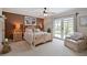 Spacious bedroom with light wood frame bed, matching nightstands, and access to outdoor space at 14344 83Rd Pl, Seminole, FL 33776