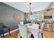 Elegant dining room featuring a chandelier, and decorative compass on a dark gray accent wall at 14344 83Rd Pl, Seminole, FL 33776