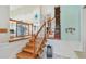 Inviting entryway with light wood stairs and decorative wall art at 14344 83Rd Pl, Seminole, FL 33776