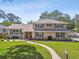 Charming two-story home with a manicured lawn, complemented by a brick walkway and beautiful landscaping at 14344 83Rd Pl, Seminole, FL 33776