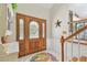 Spacious foyer with stained glass sidelights, a patterned rug, and staircase at 14344 83Rd Pl, Seminole, FL 33776