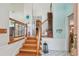 Open foyer featuring wood staircase with white railing, and views to other rooms at 14344 83Rd Pl, Seminole, FL 33776