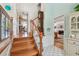 Bright foyer with wood staircase, tiled flooring, and a glimpse into the living spaces at 14344 83Rd Pl, Seminole, FL 33776