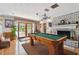 Entertainment room with a pool table, fireplace, and access to the outdoor patio at 14344 83Rd Pl, Seminole, FL 33776
