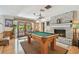 Entertaining game room with pool table, brick fireplace, and access to the outdoor patio at 14344 83Rd Pl, Seminole, FL 33776